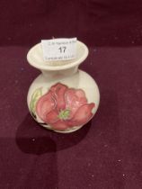 A Moorcroft Magnolia pattern with pink flowers to white back ground bud vase - 10cm high,