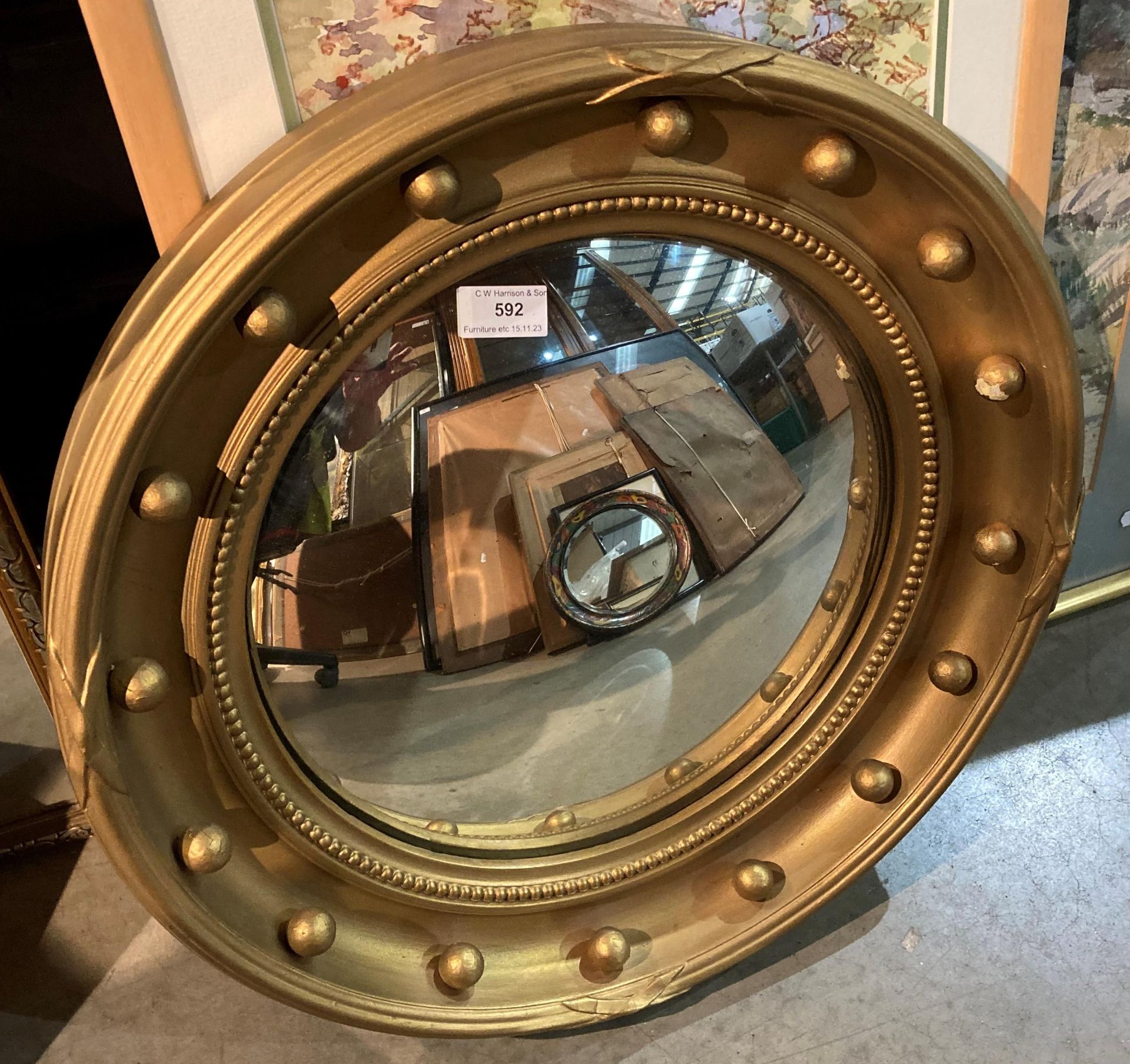 A gilt painted porthole style wall mirror - 54 x 54cm (saleroom location: gallery)