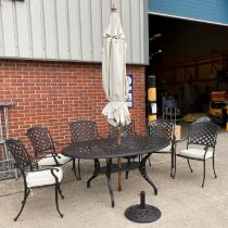 A black metal oval garden table with under-tray (165 x 115cm) complete with six matching armchairs