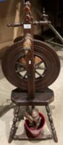 A 19th century spinning wheel (as viewed - parts as in photo to front of wheel) 97cm high (saleroom