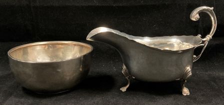 Silver hallmarked gravy boat with shaped edge and scroll handle and a silver hallmarked bowl -