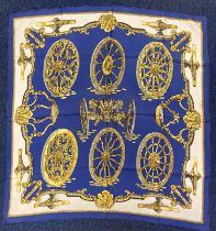 Hermes silk scarf 'Roues de Canon' by Caty Latham, depicting cannon carriage wheels, in blue,