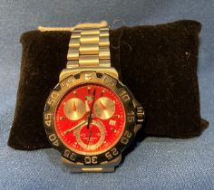 Tag Heuer Formula 1 gents watch with red face and black outer rim,