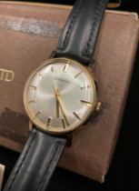 GENT'S GARRARD WRISTWATCH in gold (no hallmarks visible) with black and leather strap,