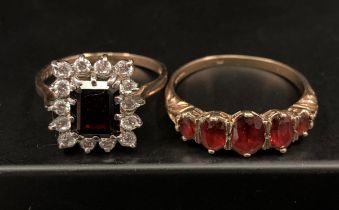 Two 9ct gold rings - five graduated garnet stone ring (size X) and a square deep red stone