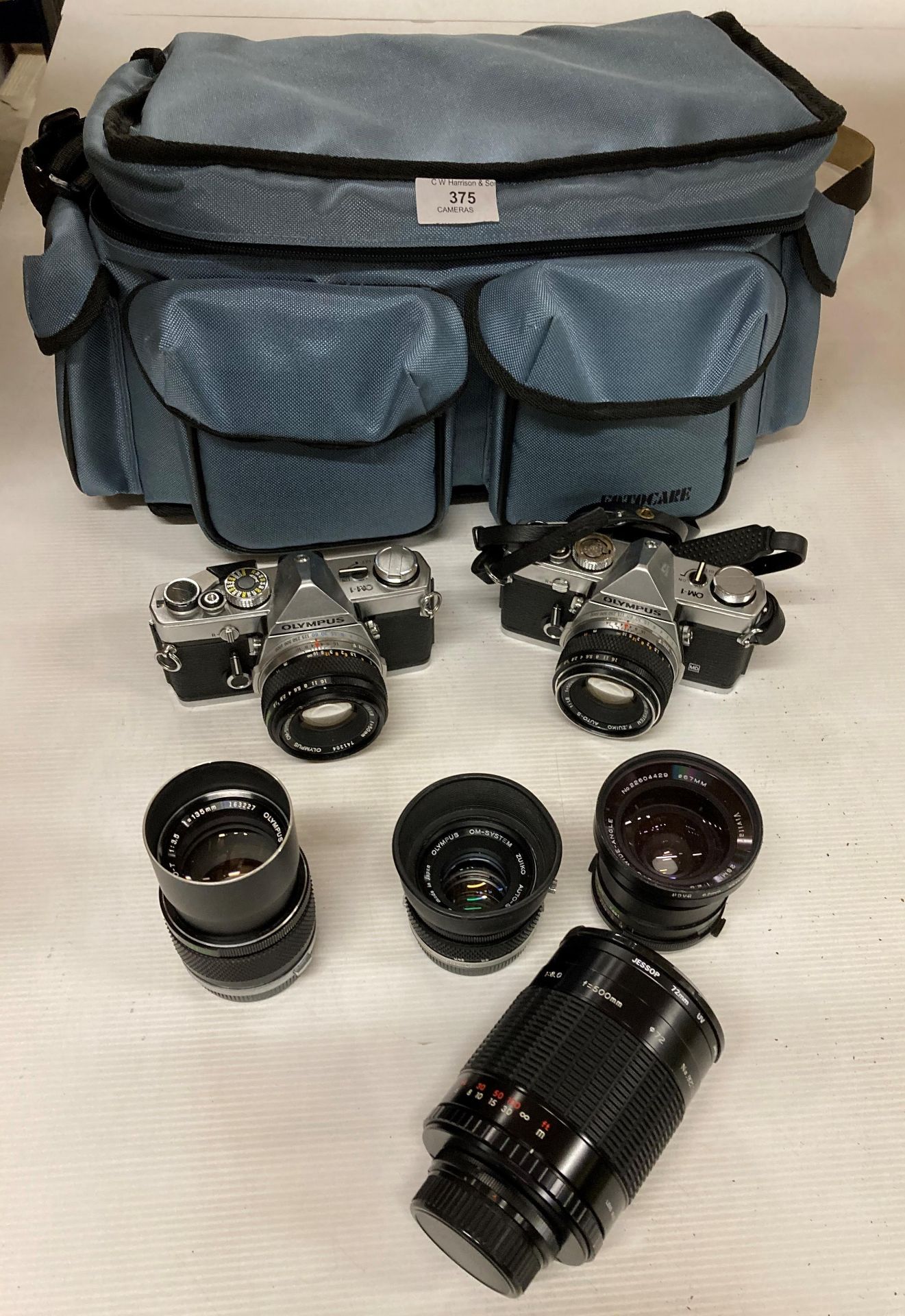 2 x Olympus OM1 cameras and 4 x assorted lens in blue carry case (R13)