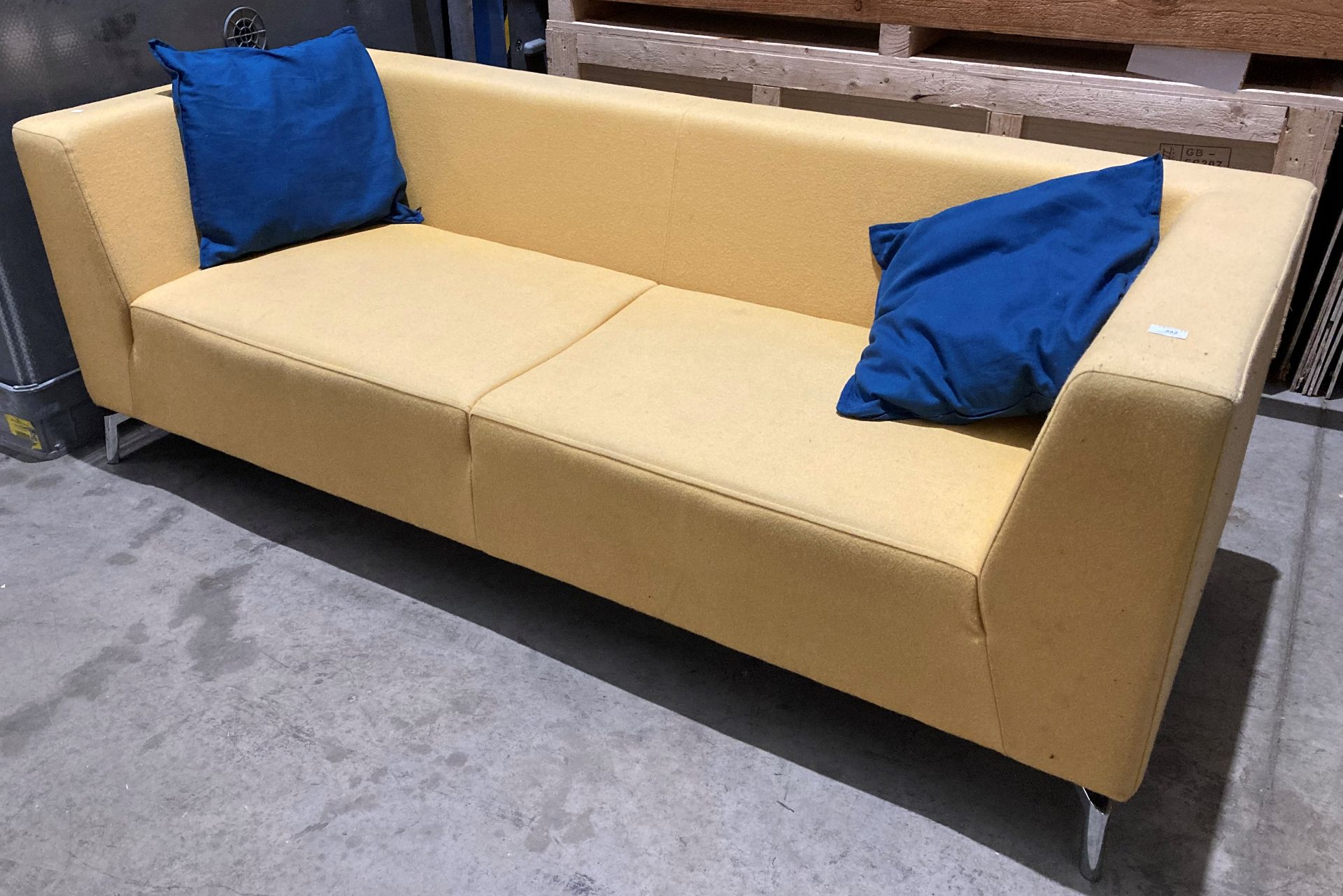 Yellow upholstered low-back three-seater settee on chrome legs (saleroom location: QD10)