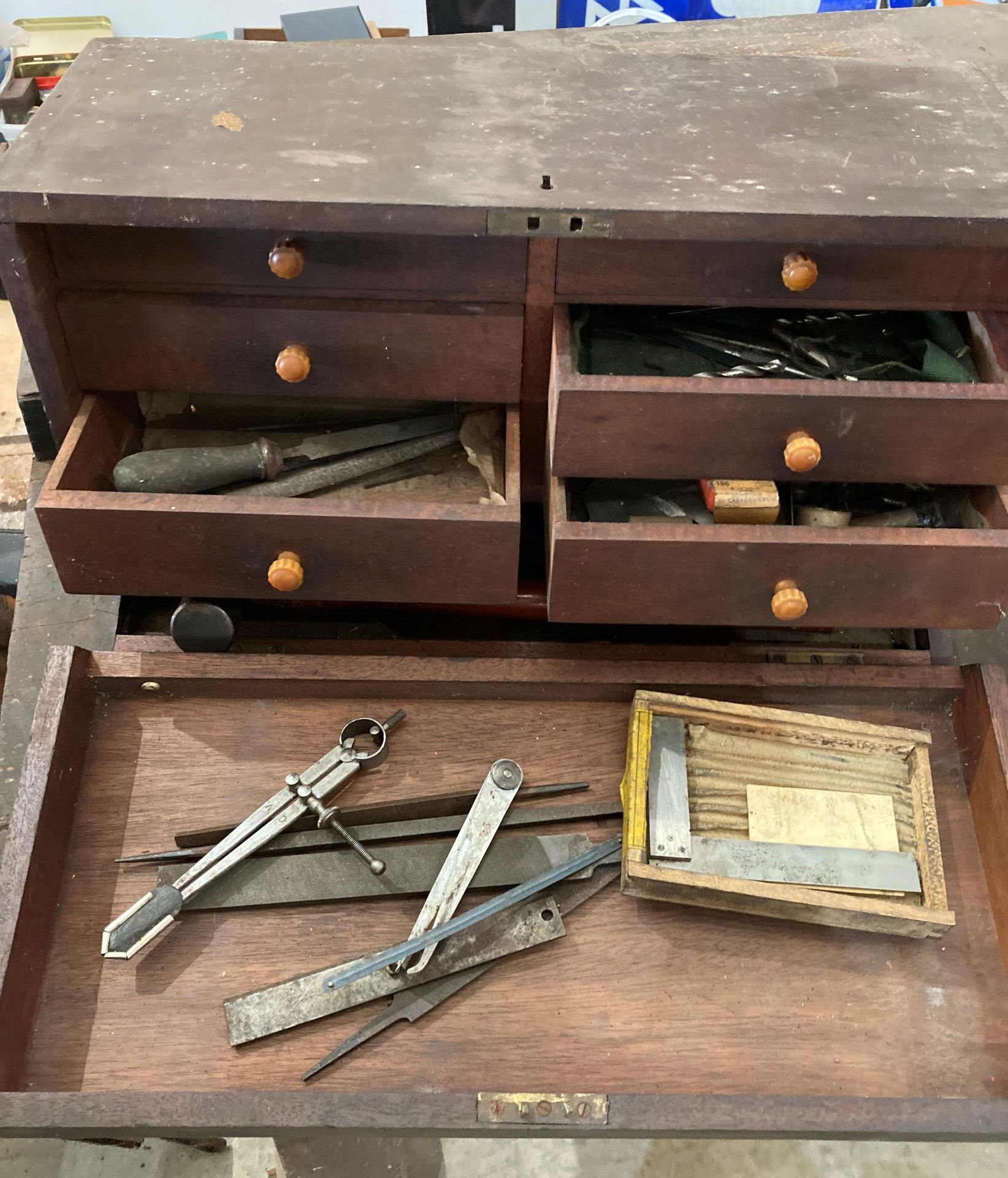 Vintage mahogany six-drawer drop-front tool box (one handle damaged) and small quantity of assorted