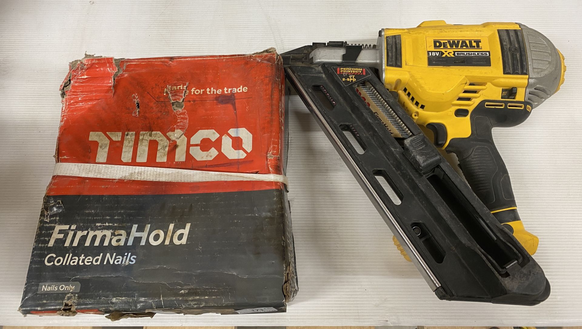 A similar DeWalt DCK264P2 nail gun and box of Timco firmahold nails (no battery or charger)