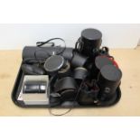 A selection of camera lenses including a large Ricoh, Mamiya, Helios,