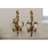 A pair of French Empire style gilded two branch electric wall lights