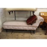 A 19th Century upholstered day bed on turned legs and castors, approx.
