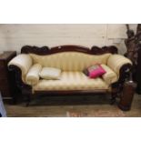A Victorian mahogany framed scroll end settee with carved back and arms