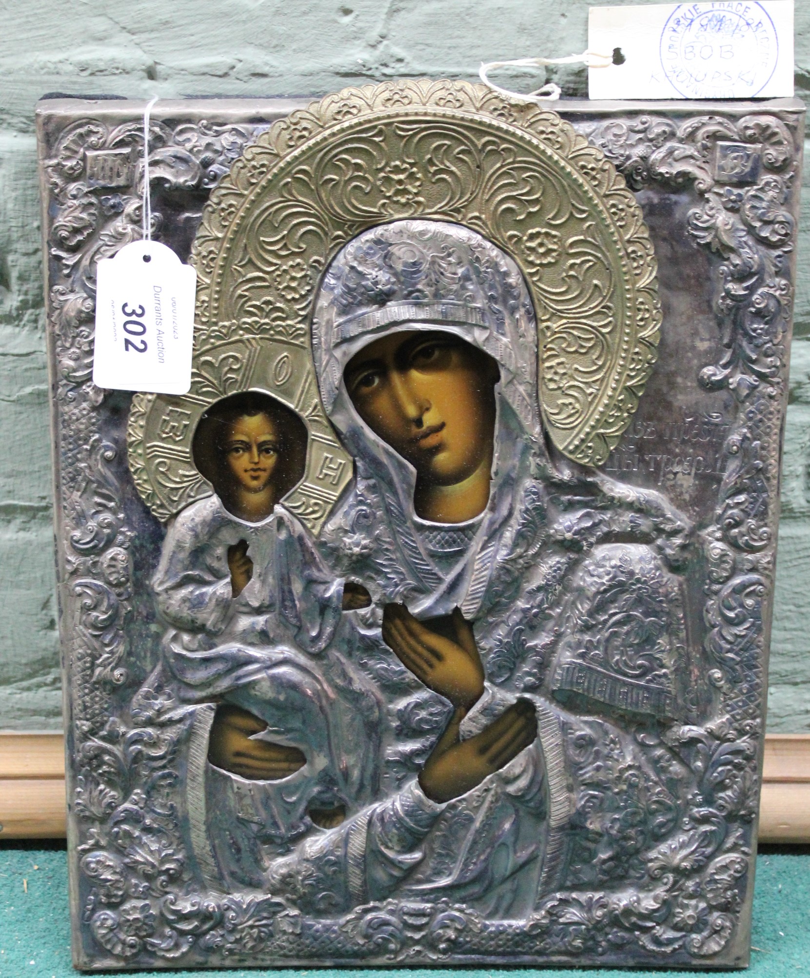 A Polish white metal cased religious icon of the Madonna and China,