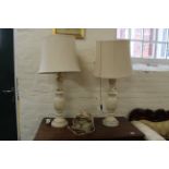 A pair of large onyx table lamps and a two branch mirror back wall light