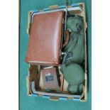 A small suitcase with various metal printing plates plus a bagged monocular and a vintage Bakelite