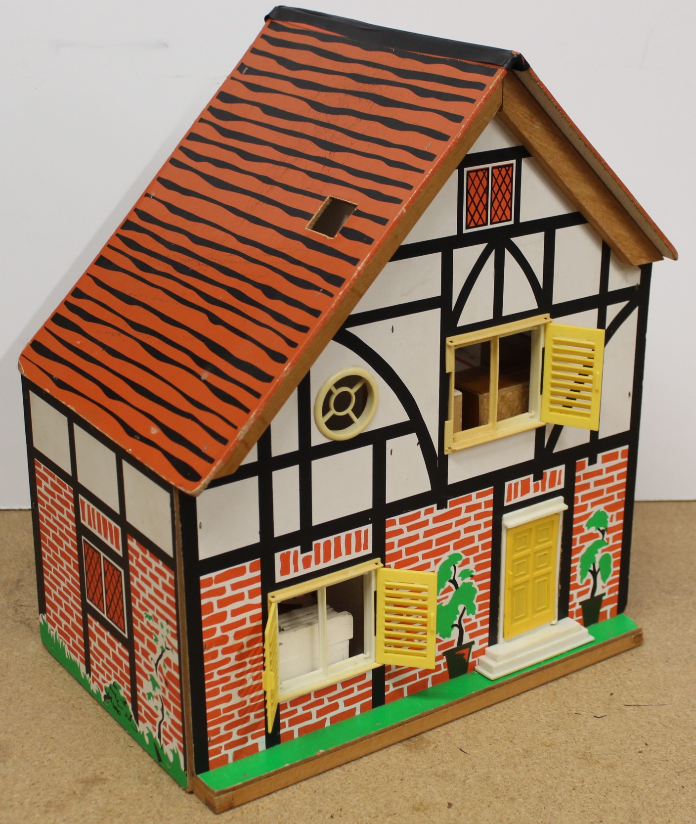 A vintage wooden and board constructed dolls house,