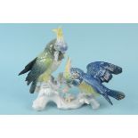A Karl Ens figure group of two macaw parrots on a branch,