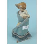 A Lladro figure of a young girl cradling a lamb
