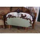 A carved mahogany upholstered head and foot board for a 5' bed adapted from a Victorian sideboard