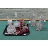 A pair of heavy cut glass William IV claret jugs (as found), three Victorian decanters,