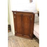 An early 19th Century oak corner cupboard