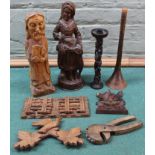 A selection of carved wooden figurines etc including folding sliding book stand, nut crackers,
