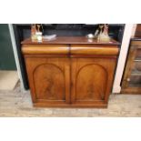 An early Victorian mahogany chiffonier base with convex drawers and arched panel doors