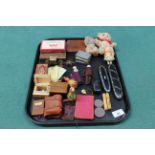 A mixed tray with items of interest including miniature books, Victorian spectacle cases,