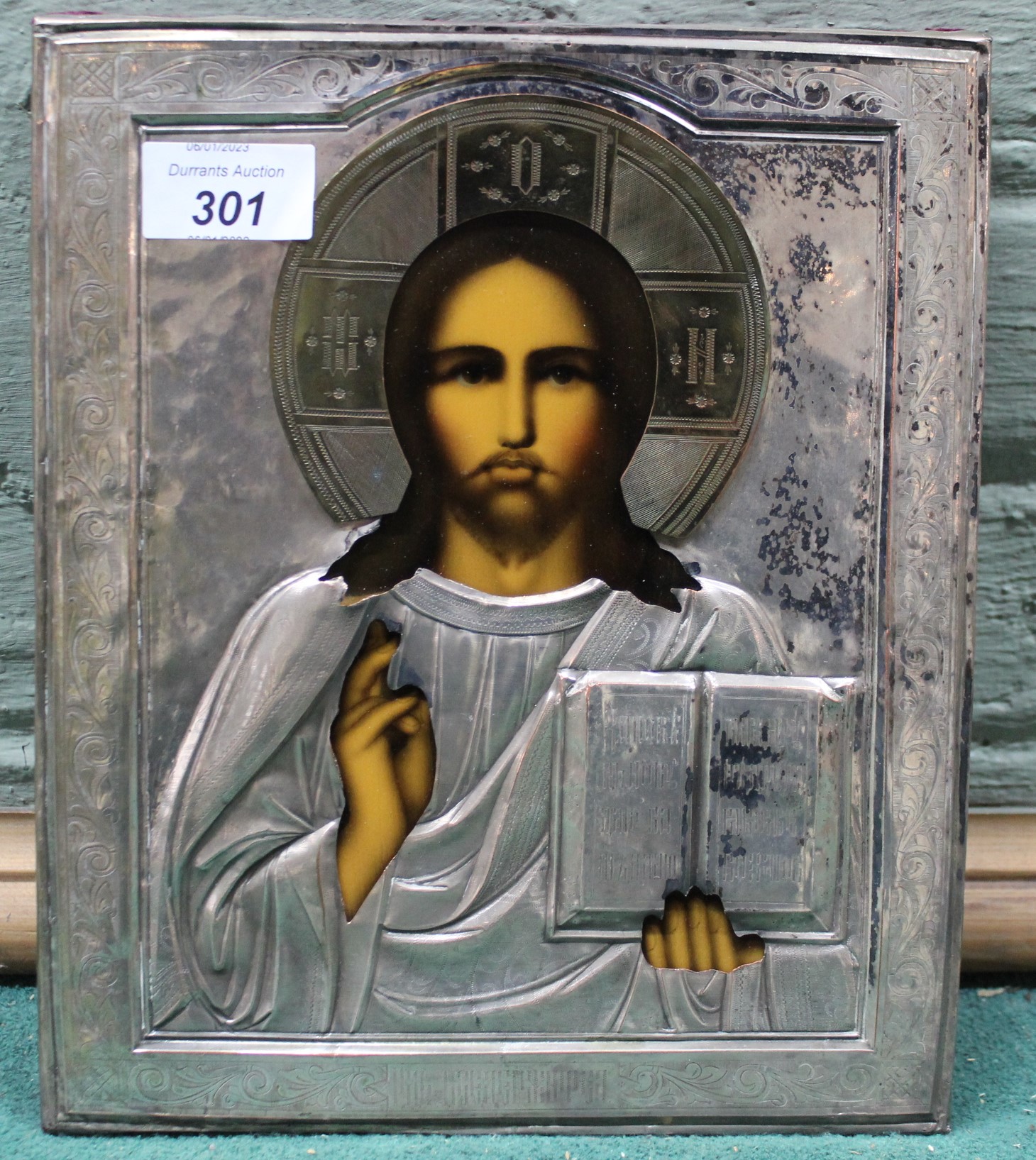 A white metal cased religious icon of Jesus,