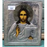 A white metal cased religious icon of Jesus,