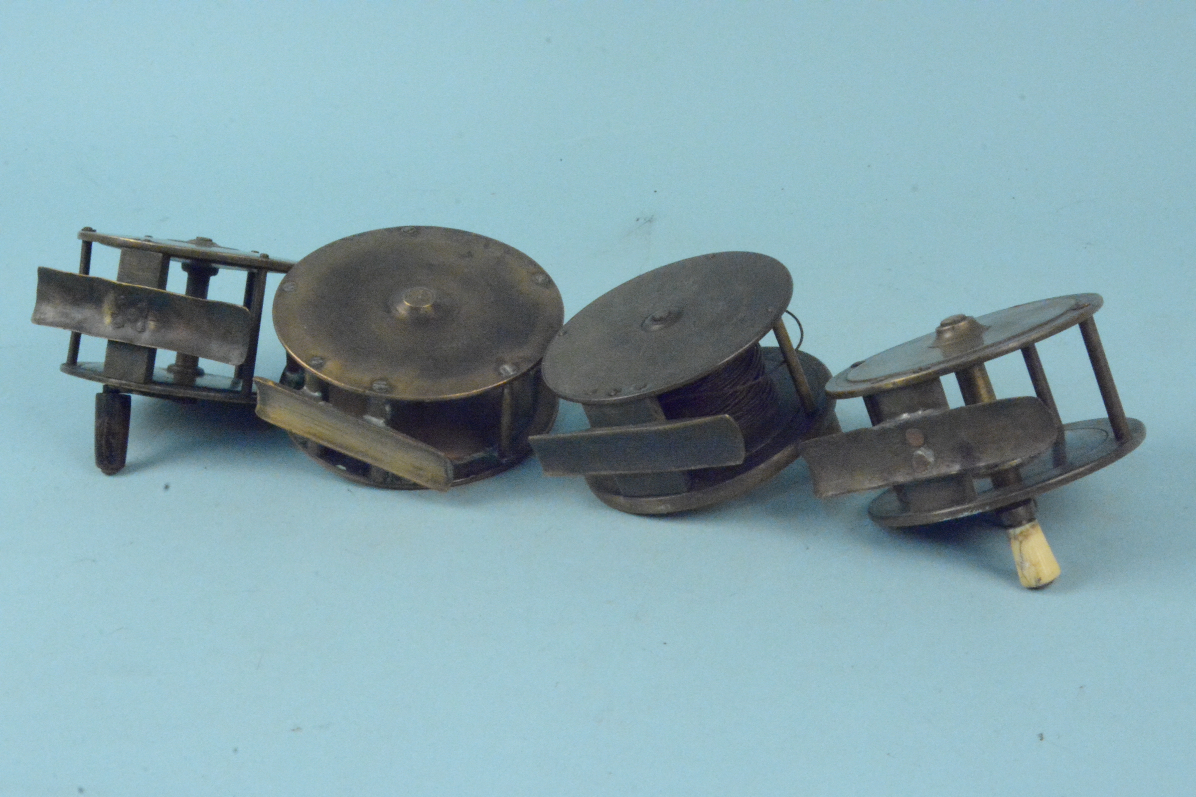 Four unnamed early brass plate wind reels - Image 3 of 3