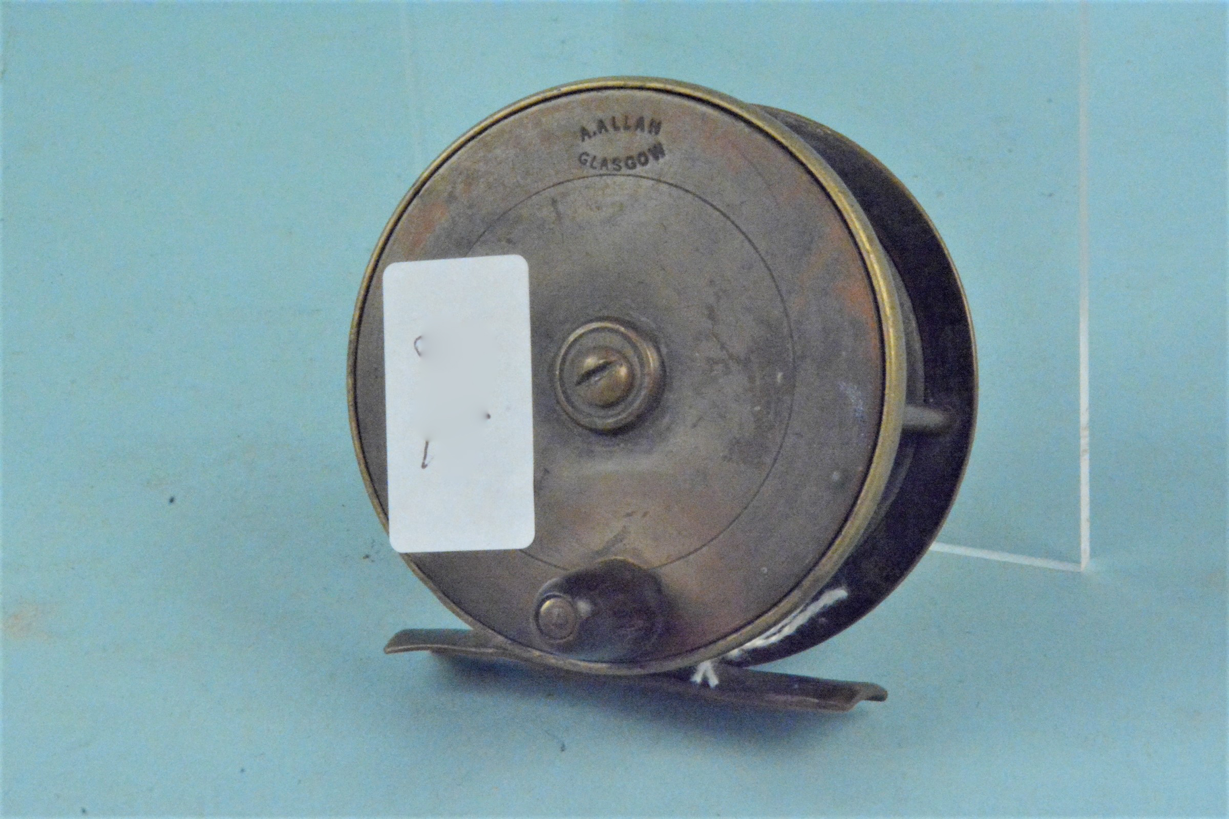 A 3" brass reel by A Allan,