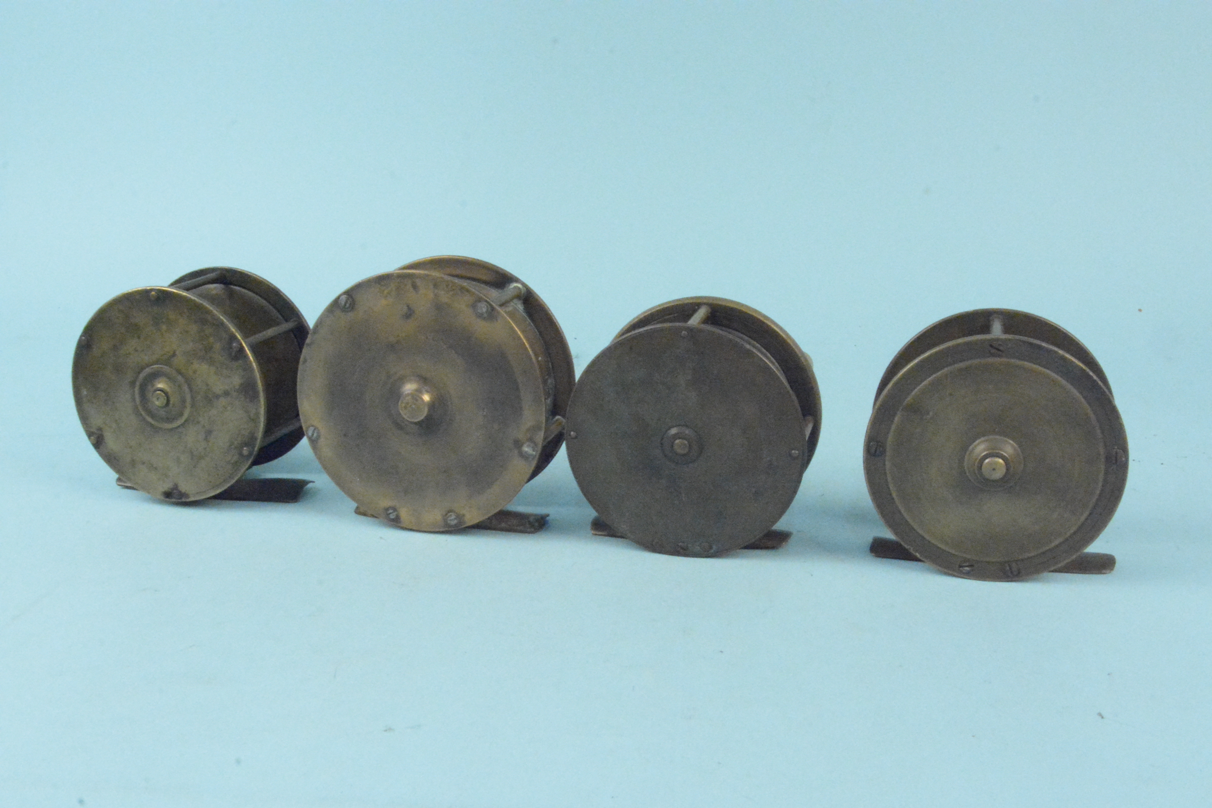 Four unnamed early brass plate wind reels - Image 2 of 3