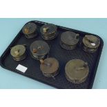 A selection of eight early brass plate wind reels