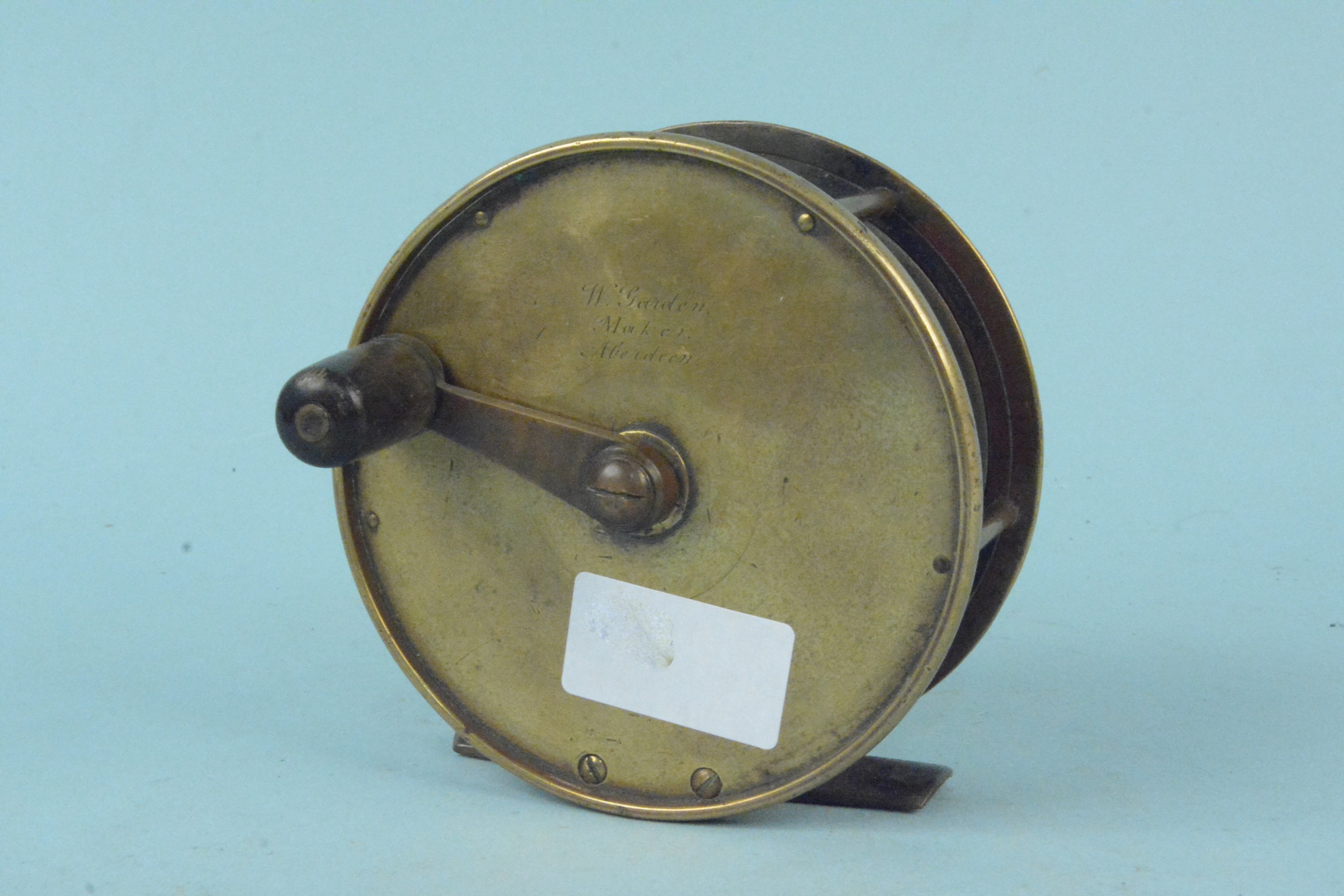 A 4 1/4" brass reel by W Gordon,