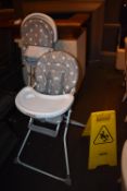 *Two Highchairs and a Warning Sign
