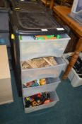 Plastic Four Drawer Storage Chest Containing Child