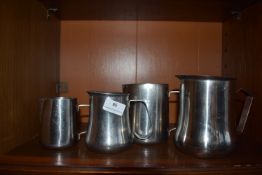 *Four Stainless Steel Jugs