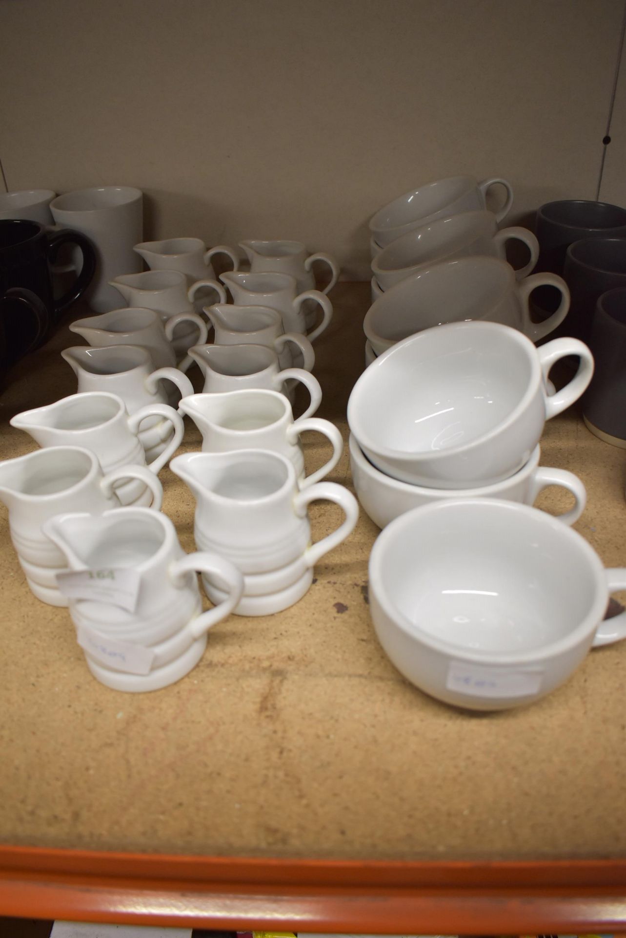 Quantity of Milk Jugs and White Mugs