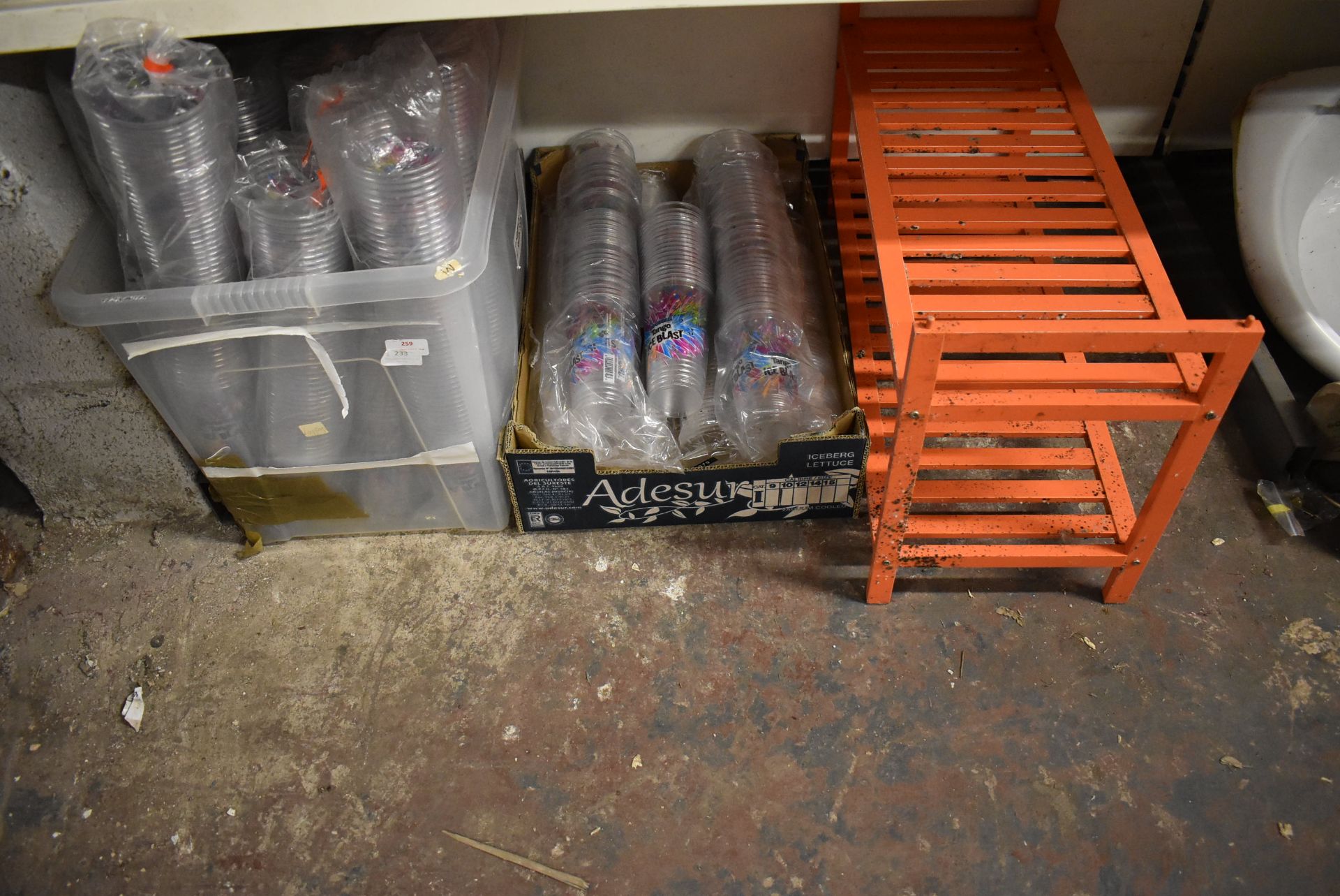 Quantity of Tango Ice Blast Plastic Cups and an Orange Shoe Rack