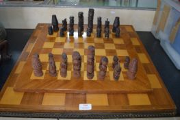 Three Wooden Chessboards and a Carved African Chess Set