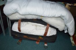 Suitcase and a Quantity of Bedding