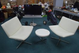 Two Cream Swivel Chairs, and a Coffee Table