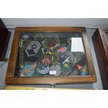 Two Small Tabletop Display Cases Containing Reproduction Military Cloth Badges