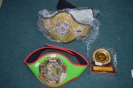 Two Tie Boxing Belts and a Trophy