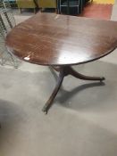 * partial wooden table on castors - originally park of oval table, used as large console table.