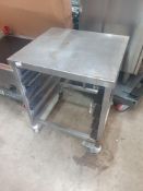 * S/S table on castor with tray racks