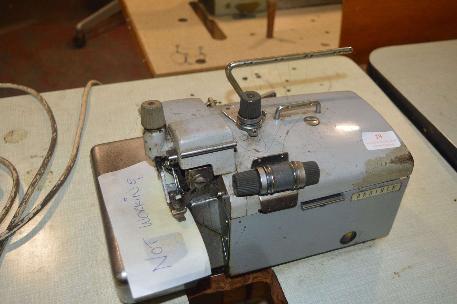 Brother Two Thread Overlocker (requires repairs) on Table with Electric Motor