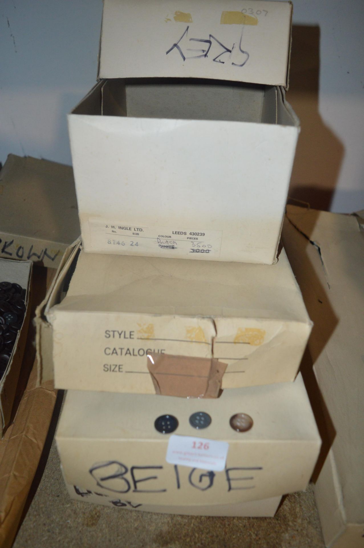 Four Boxes of Beige and Grey Buttons